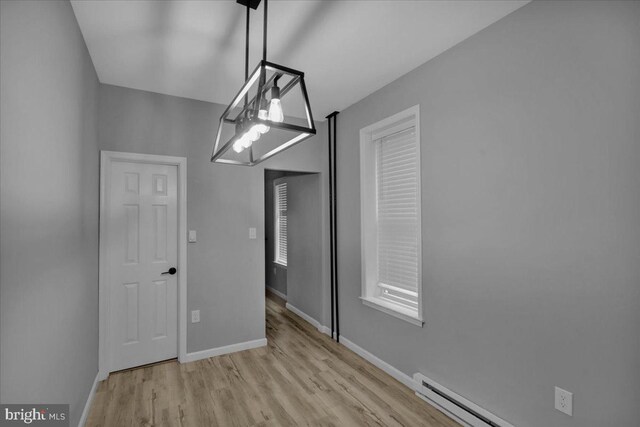 446 S 15th St, Reading, PA 19602 - unfurnished dining area with wood finished floors and a baseboard heating unit