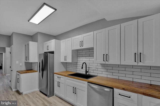 446 S 15th St, Reading, PA 19602 - kitchen featuring butcher block countertops, stainless steel appliances, white cabinetry, and light wood-style flooring