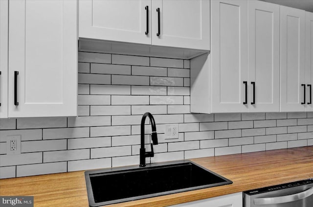 446 S 15th St, Reading, PA 19602 - kitchen featuring dishwasher, white cabinetry, and decorative backsplash
