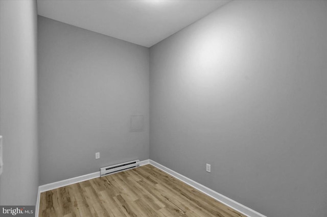 446 S 15th St, Reading, PA 19602 - empty room featuring a baseboard radiator and wood finished floors