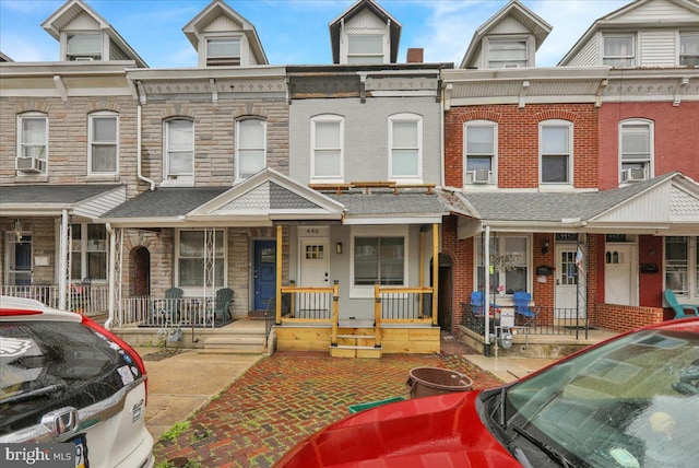 446 S 15th St, Reading, PA 19602 - view of property featuring a porch, brick siding, and cooling unit