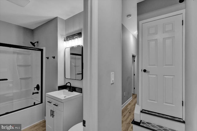 446 S 15th St, Reading, PA 19602 - full bathroom with vanity, wood finished floors, and bath / shower combo with glass door