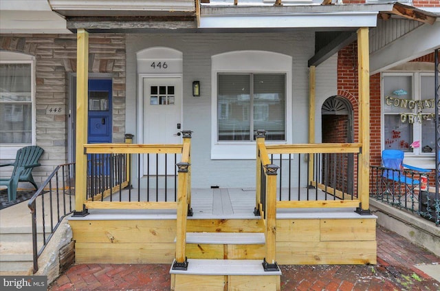446 S 15th St, Reading, PA 19602 - property entrance featuring stone siding, a porch, and brick siding