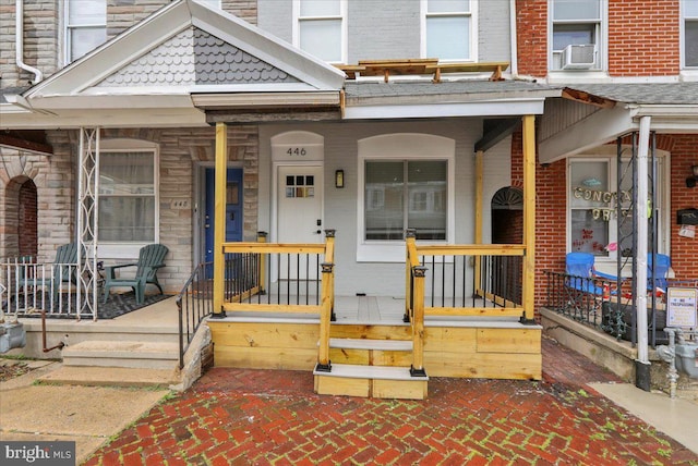 446 S 15th St, Reading, PA 19602 - doorway to property with a porch, cooling unit, and brick siding