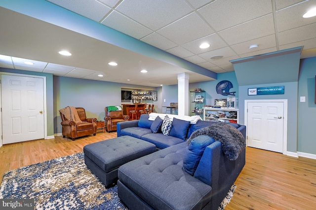 1506 Cloverhill Rd, Pottstown, PA 19464 - living area featuring a dry bar, a paneled ceiling, light wood finished floors, decorative columns, and recessed lighting