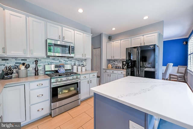1506 Cloverhill Rd, Pottstown, PA 19464 - kitchen with stainless steel appliances, white cabinetry, tasteful backsplash, light countertops, and recessed lighting