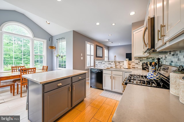 1506 Cloverhill Rd, Pottstown, PA 19464 - kitchen with stainless steel appliances, light countertops, tasteful backsplash, lofted ceiling, and light wood-type flooring