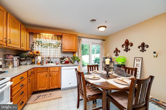 2170 Reading Blvd, Reading, PA 19609 - kitchen featuring white appliances, light countertops, brown cabinets, and light flooring