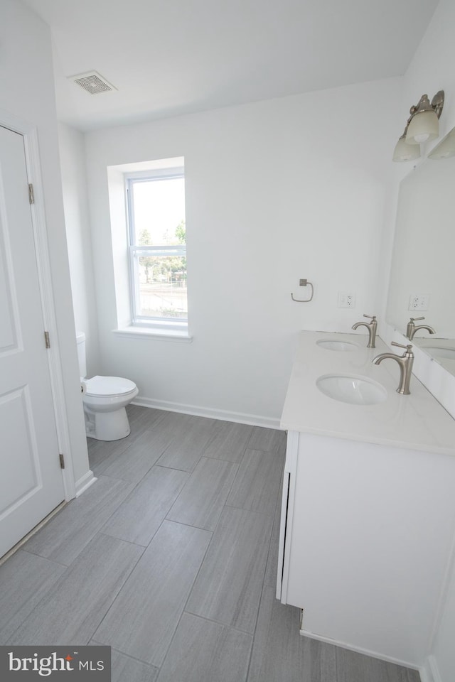 1615 Rowan St, Philadelphia, PA 19140 - bathroom with double vanity and wood tiled floors