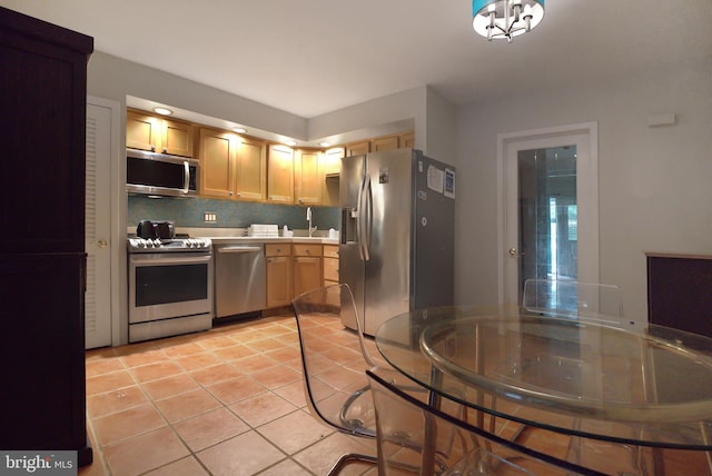 20B Oscar Hammerstein Way Unit 20B, New Hope, PA 18938 - kitchen with stainless steel appliances, light tile patterned floors, light countertops, and tasteful backsplash