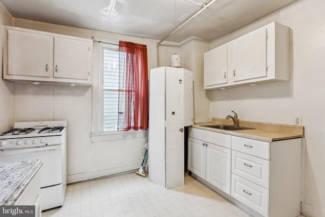 111/2 College Ave, Annapolis, MD 21401 - kitchen with white range with gas stovetop, white cabinetry, light countertops, and light floors