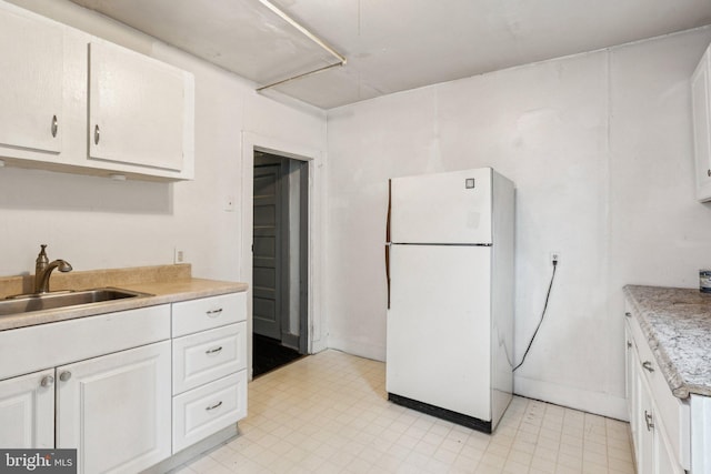 111/2 College Ave, Annapolis, MD 21401 - kitchen featuring freestanding refrigerator, light countertops, white cabinets, and light floors