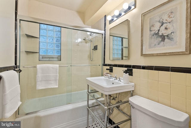 2500 Q St NW Unit 545, Washington, DC 20007 - full bath with tile walls, combined bath / shower with glass door, and a wainscoted wall