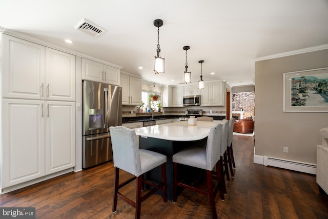 4 Concord Way, Chadds Ford, PA 19317 - kitchen with stainless steel appliances, a baseboard heating unit, recessed lighting, white cabinetry, and a breakfast bar area
