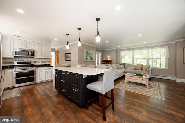 4 Concord Way, Chadds Ford, PA 19317 - kitchen with stainless steel appliances, ornamental molding, a baseboard radiator, white cabinetry, and a breakfast bar
