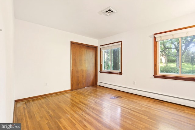20 Birch Ct, Lancaster, PA 17603 - unfurnished room featuring a baseboard radiator and wood finished floors