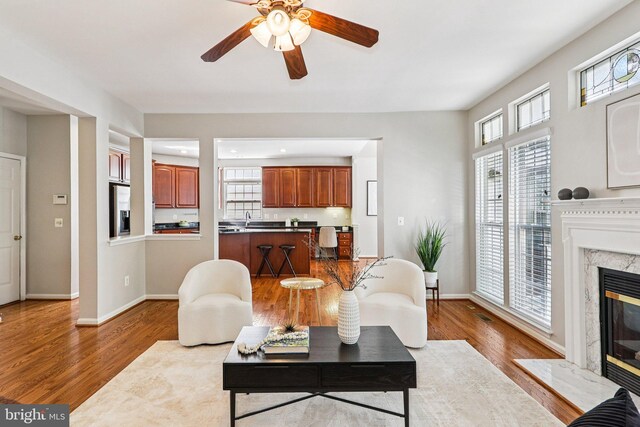 5570 La Vista Dr, Alexandria, VA 22310 - living room with healthy amount of natural light, a high end fireplace, and wood finished floors