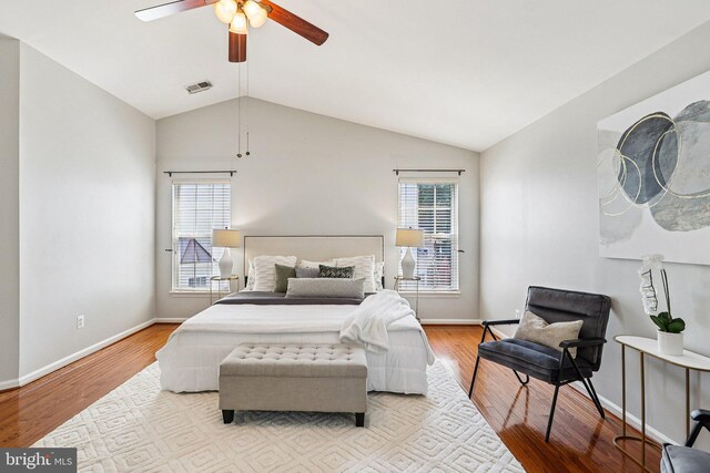 5570 La Vista Dr, Alexandria, VA 22310 - bedroom with multiple windows, vaulted ceiling, wood finished floors, and a ceiling fan
