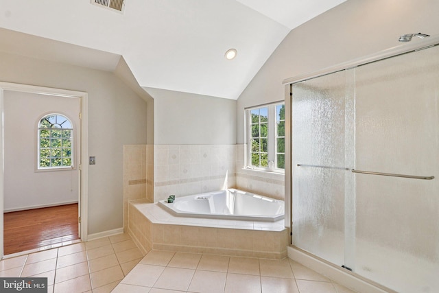 5570 La Vista Dr, Alexandria, VA 22310 - full bath with healthy amount of natural light, tile patterned floors, a bath, lofted ceiling, and a stall shower