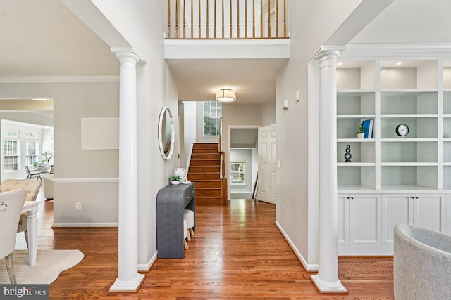 5570 La Vista Dr, Alexandria, VA 22310 - foyer with decorative columns, wood finished floors, plenty of natural light, and crown molding