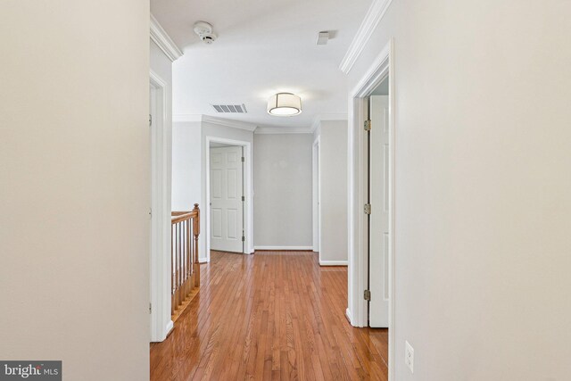 5570 La Vista Dr, Alexandria, VA 22310 - hallway with light wood-style flooring, ornamental molding, and an upstairs landing