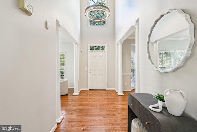5570 La Vista Dr, Alexandria, VA 22310 - entrance foyer with ornate columns, light wood-type flooring, and a towering ceiling