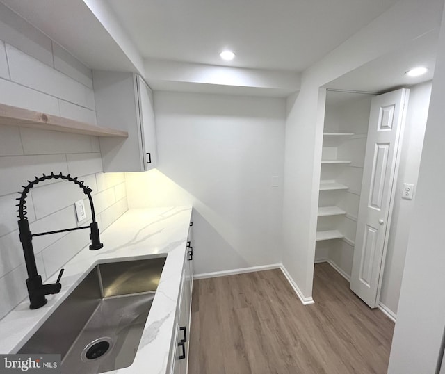 7720 Tremayne Pl Unit 107, Mclean, VA 22102 - kitchen with light wood finished floors, light stone counters, open shelves, backsplash, and recessed lighting