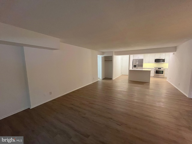 7720 Tremayne Pl Unit 107, Mclean, VA 22102 - unfurnished living room featuring dark wood-type flooring and baseboards