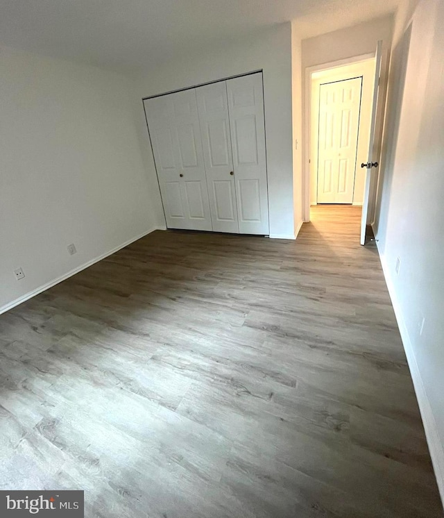 7720 Tremayne Pl Unit 107, Mclean, VA 22102 - unfurnished bedroom featuring wood finished floors and a closet