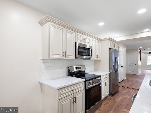 210 N Franklin St, Wilmington, DE 19805 - kitchen with stainless steel appliances, dark wood-style floors, recessed lighting, decorative backsplash, and light stone counters