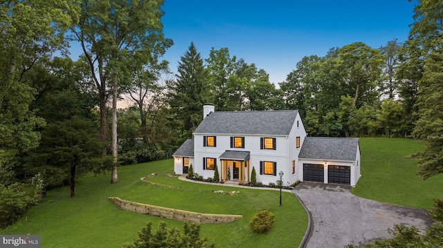 7819 Overbrook, Ruxton, MD 21204 - modern farmhouse featuring a chimney, a garage, asphalt driveway, and a front lawn