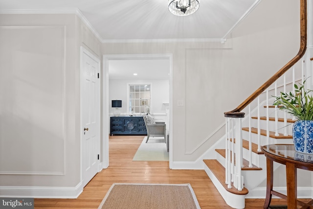 7819 Overbrook, Ruxton, MD 21204 - foyer with wood finished floors, stairs, crown molding, and a chandelier