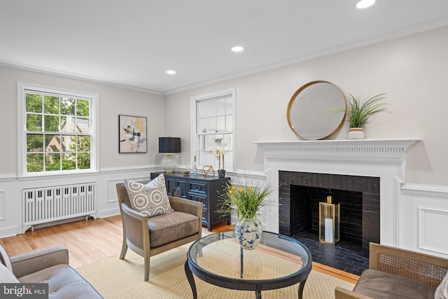 7819 Overbrook, Ruxton, MD 21204 - living room with radiator, wood finished floors, wainscoting, a fireplace with flush hearth, and recessed lighting