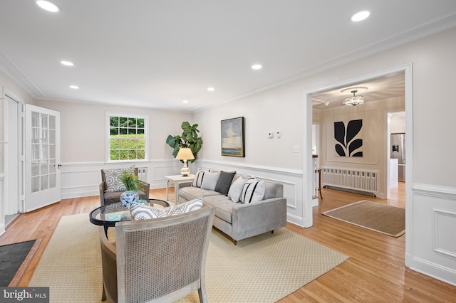 7819 Overbrook, Ruxton, MD 21204 - living room featuring radiator, crown molding, light wood-style flooring, wainscoting, and recessed lighting