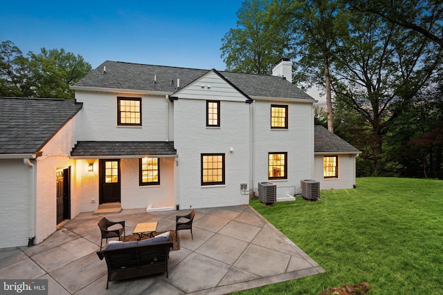 7819 Overbrook, Ruxton, MD 21204 - back of property with a chimney, a patio, a yard, brick siding, and a shingled roof