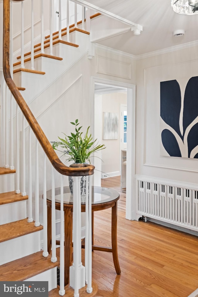 7819 Overbrook, Ruxton, MD 21204 - staircase with radiator heating unit, crown molding, and wood finished floors