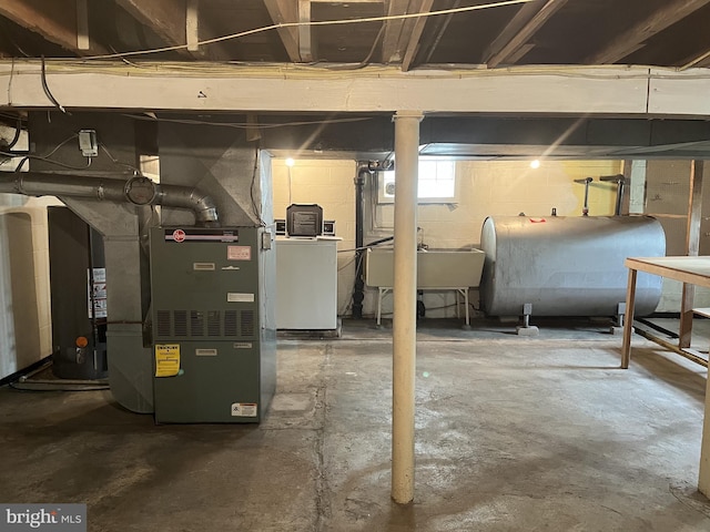 2100 Lincoln Ave, Wilmington, DE 19809 - basement featuring oil tank, washer / clothes dryer, heating unit, and water heater