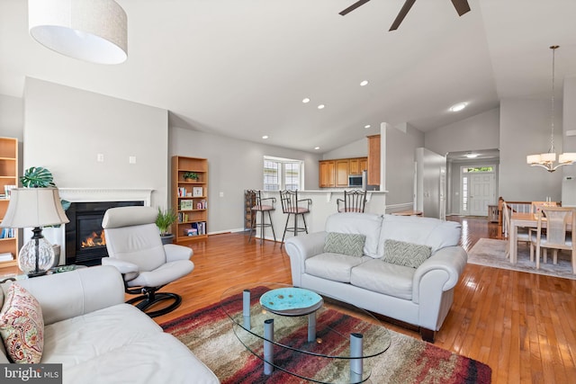 3709 Apple Cider Ct, Dumfries, VA 22025 - living room with light wood-style floors, ceiling fan, a glass covered fireplace, vaulted ceiling, and recessed lighting