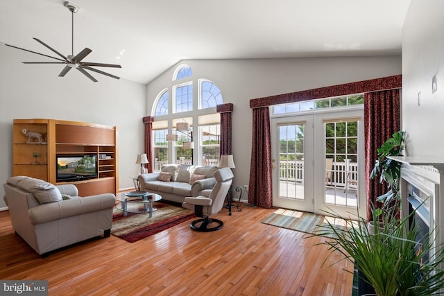 3709 Apple Cider Ct, Dumfries, VA 22025 - living area featuring hardwood / wood-style floors, ceiling fan, a multi sided fireplace, and high vaulted ceiling
