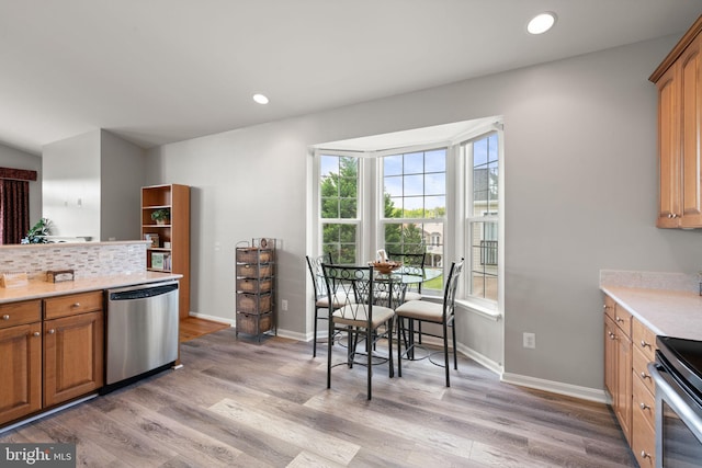 3709 Apple Cider Ct, Dumfries, VA 22025 - kitchen with dishwasher, light wood-style flooring, light countertops, brown cabinets, and recessed lighting