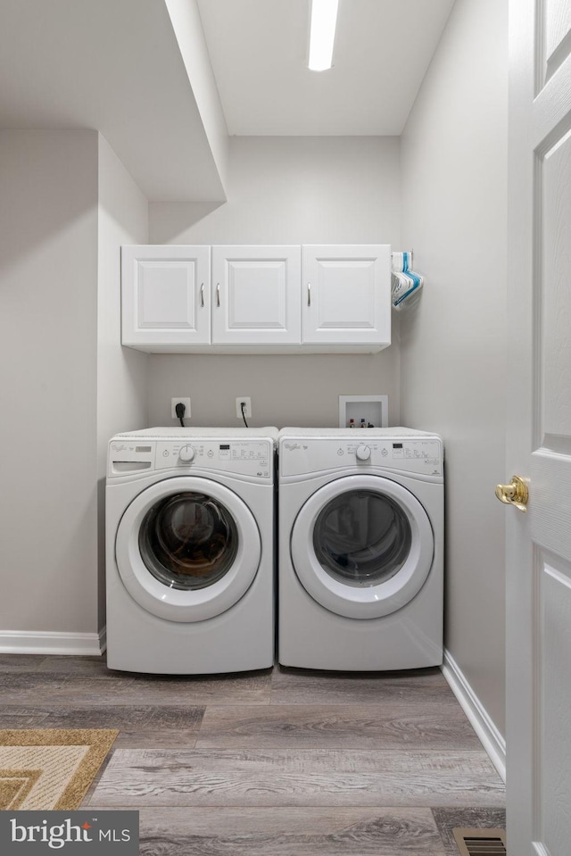 3709 Apple Cider Ct, Dumfries, VA 22025 - laundry room featuring cabinet space, independent washer and dryer, and wood finished floors