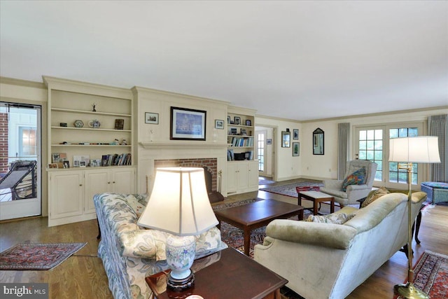 154 Deer Hill Rd, Reading, PA 19607 - living area with dark wood-style flooring, a brick fireplace, ornamental molding, and built in features