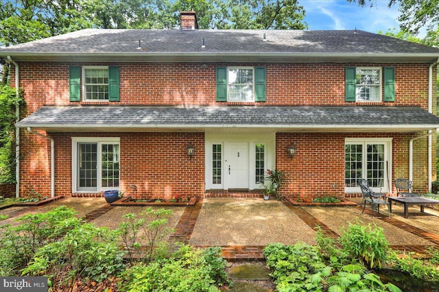 154 Deer Hill Rd, Reading, PA 19607 - back of house featuring a chimney, brick siding, and roof with shingles