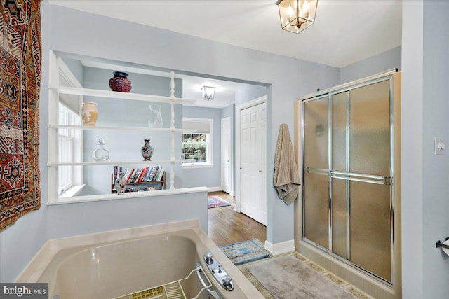154 Deer Hill Rd, Reading, PA 19607 - bathroom featuring a bath, a stall shower, and wood finished floors