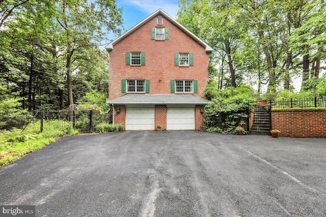 154 Deer Hill Rd, Reading, PA 19607 - view of side of home featuring asphalt driveway, brick siding, and a garage