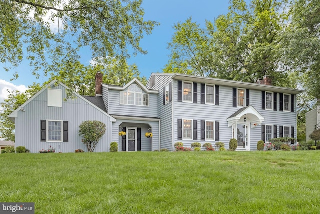 69 Hickory Ln, Chalfont, PA 18914 - colonial-style house featuring a chimney and a front lawn