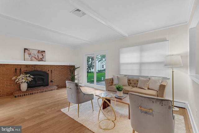 69 Hickory Ln, Chalfont, PA 18914 - living area featuring a baseboard radiator, beamed ceiling, wood finished floors, and a wood stove
