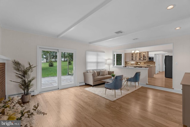 69 Hickory Ln, Chalfont, PA 18914 - living room with a chandelier, light wood finished floors, and a baseboard radiator