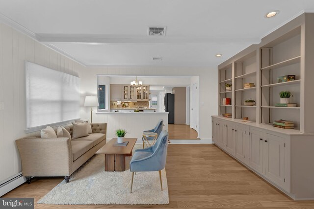 69 Hickory Ln, Chalfont, PA 18914 - living area with a chandelier, light wood-type flooring, baseboard heating, ornamental molding, and recessed lighting