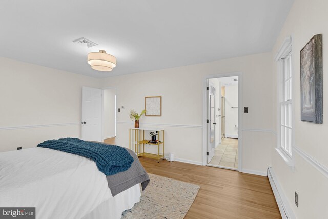 69 Hickory Ln, Chalfont, PA 18914 - bedroom featuring baseboard heating and light wood finished floors